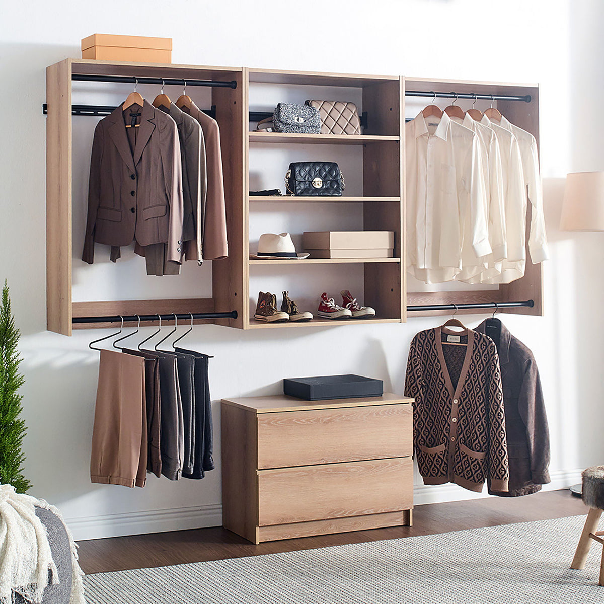 Light brown modular closet system with hanging rails, shelves, and drawer storage bench