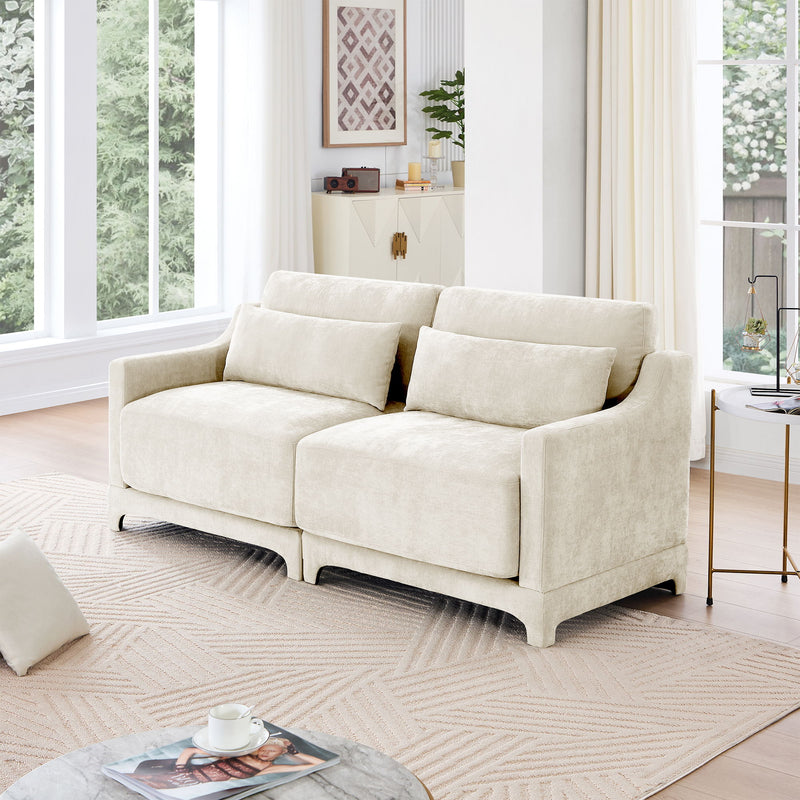 Light beige fabric sofa with two lumbar pillows and track arms