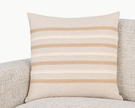Natural 22 x 22 pillow with orange and cream striped band on upholstered seat