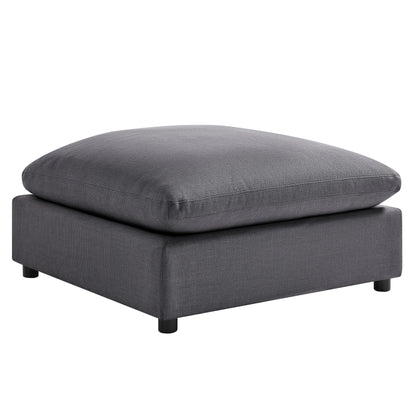 Dark gray upholstered ottoman with padded square top and short legs
