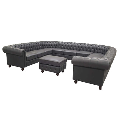 Dark gray tufted U-shape sectional sofa with central ottoman and boxy side cushions