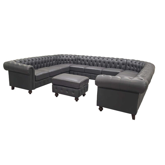 Dark gray tufted U-shape sectional sofa with central ottoman and boxy side cushions