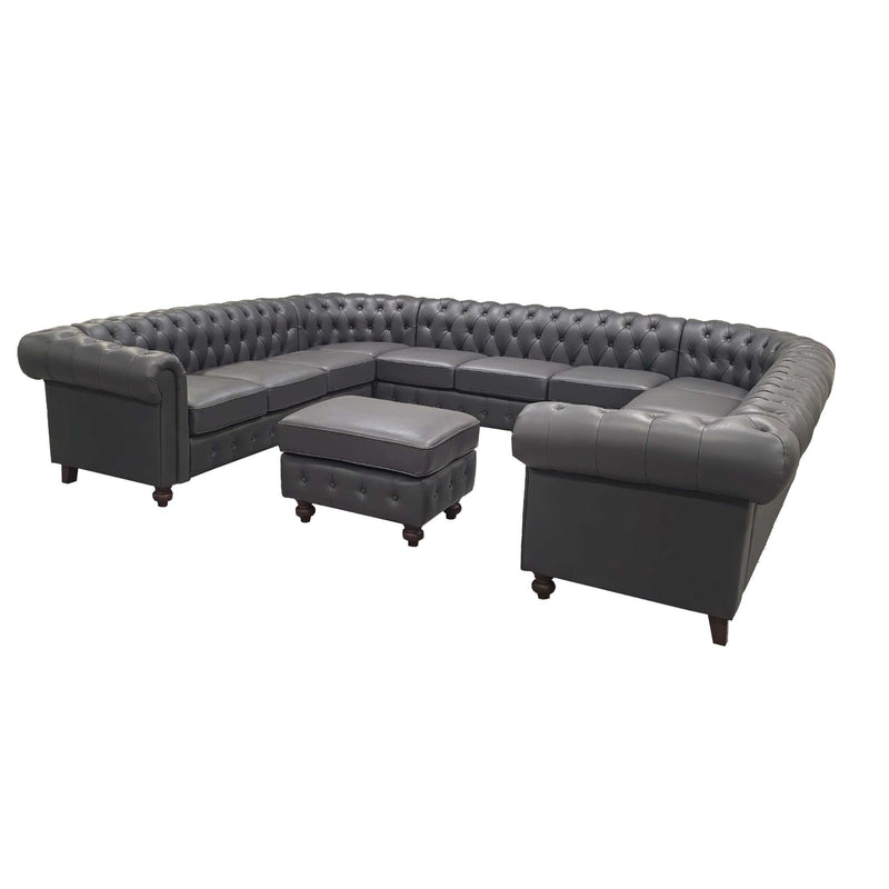 Dark gray tufted U-shape sectional sofa with central ottoman and boxy side cushions