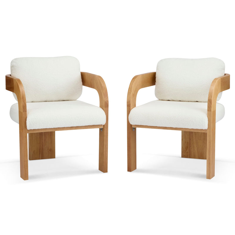Pair of white upholstered dining chairs with cushioned backs and curved wood arms