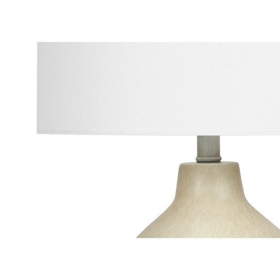 Cream fabric drum shade on beige concrete-style table lamp base