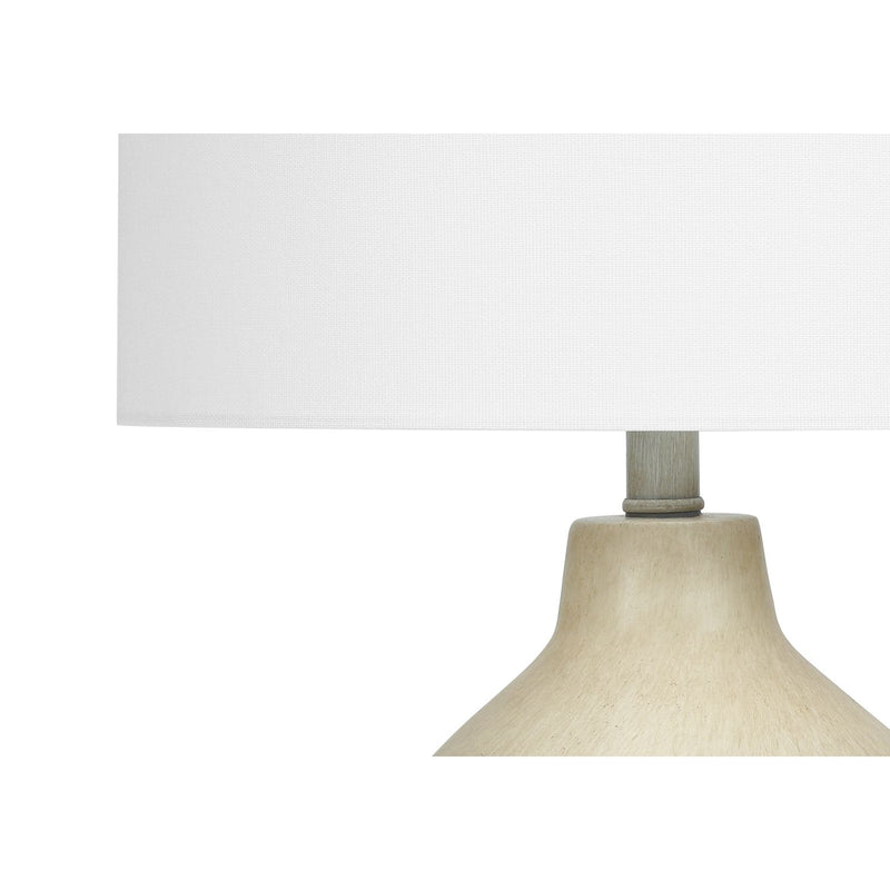 Cream fabric drum shade on beige concrete-style table lamp base