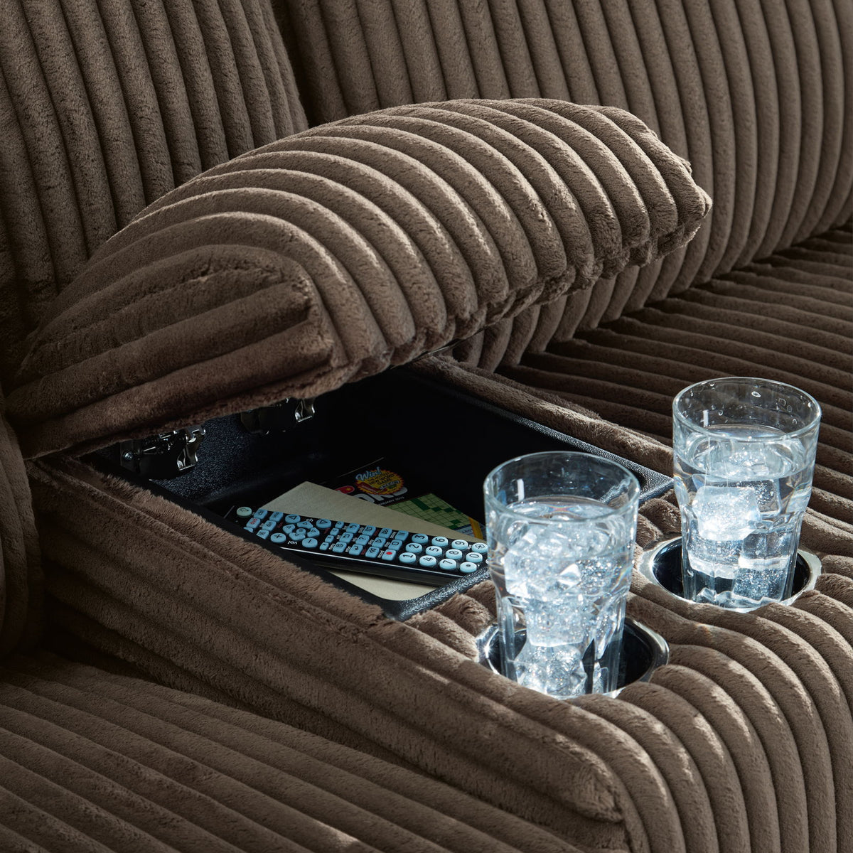 Dark brown ribbed reclining sectional sofa cushion detail with plush armrest padding