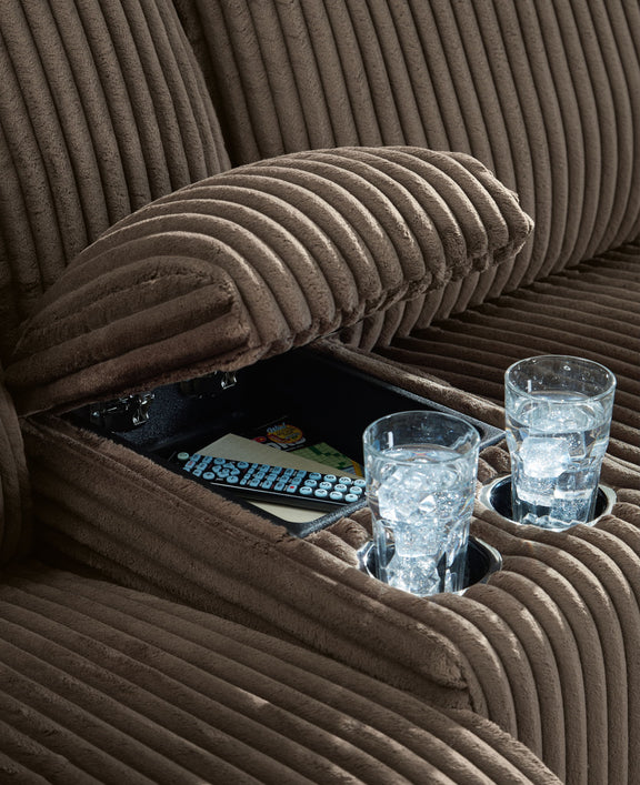 Dark brown ribbed reclining sectional sofa cushion detail with plush armrest padding