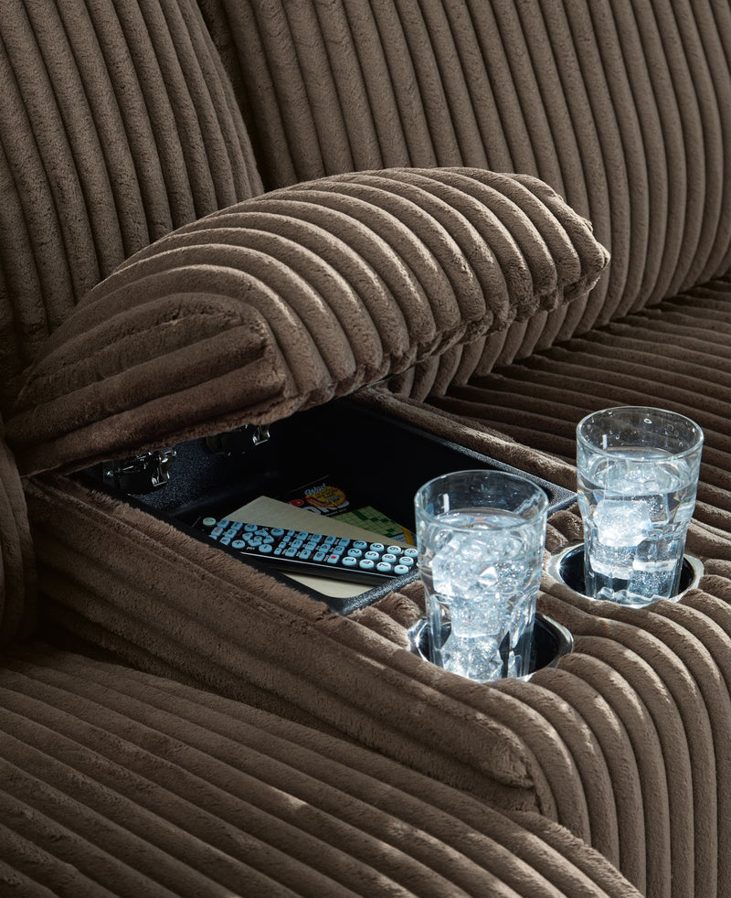 Dark brown ribbed reclining sectional sofa cushion detail with plush armrest padding
