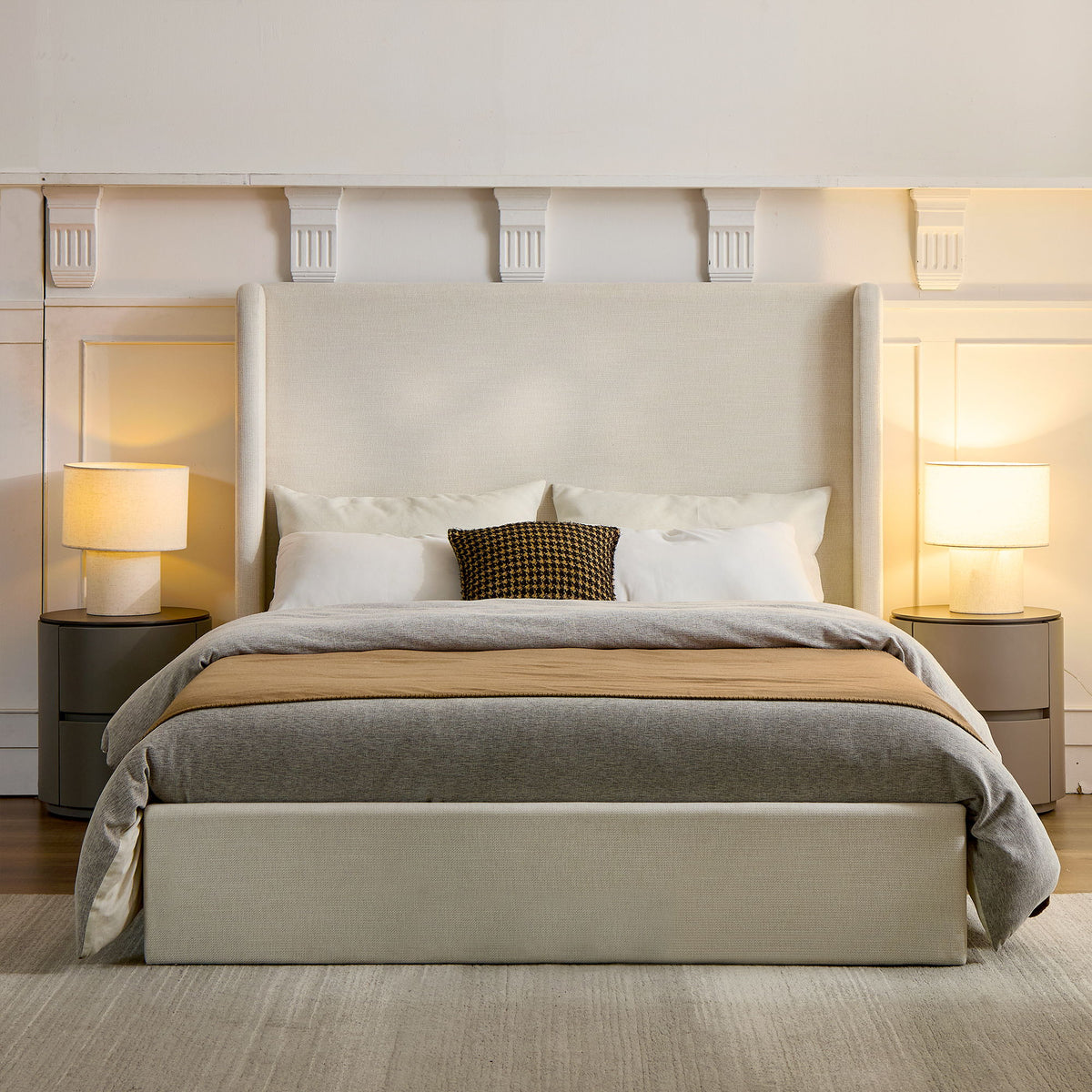 Front view of an ivory upholstered king bed with a tall wingback headboard