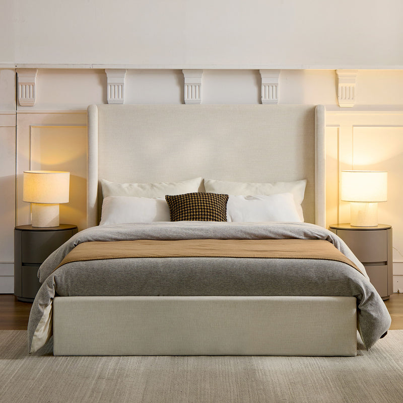 Front view of an ivory upholstered king bed with a tall wingback headboard