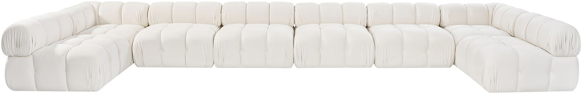 White modular sectional sofa with rounded, tufted seats and cushioned backrest