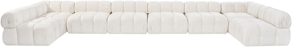 White modular sectional sofa with rounded, tufted seats and cushioned backrest