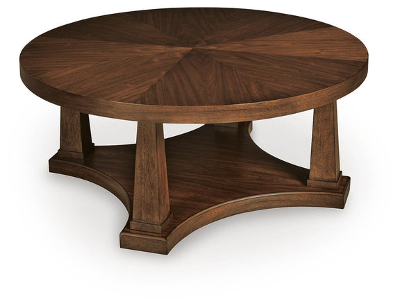 Round wooden end table with open lower shelf and carved base