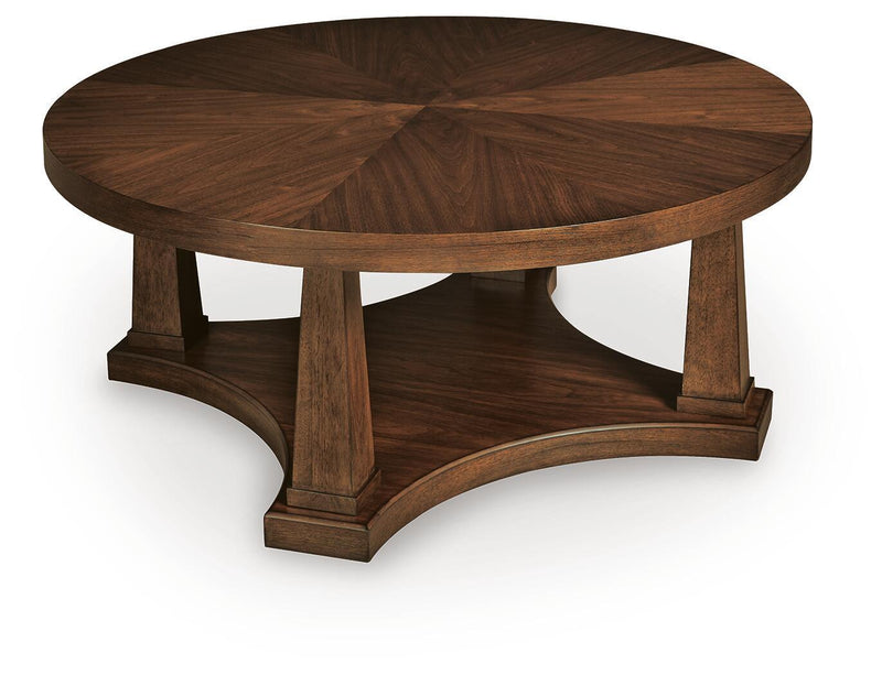 Round wooden end table with open lower shelf and carved base