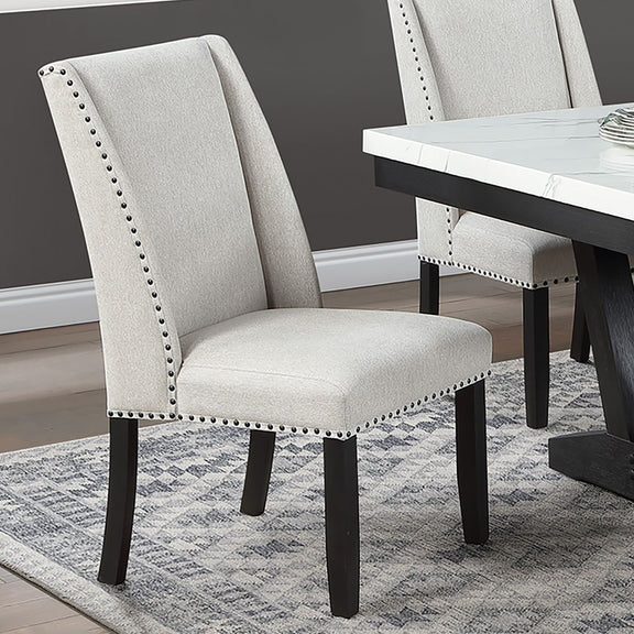 Upholstered wingback dining chair in light beige, nailhead trim, dark wood legs