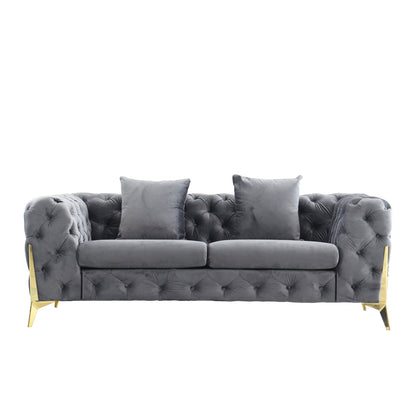 Dark gray velvet loveseat with diamond button tufting and two throw pillows, gold legs