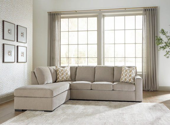 Gray sleeper sectional sofa with corner chaise and patterned accent pillows