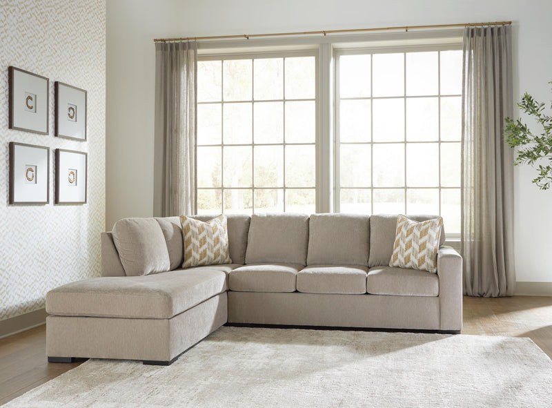 Gray sleeper sectional sofa with corner chaise and patterned accent pillows