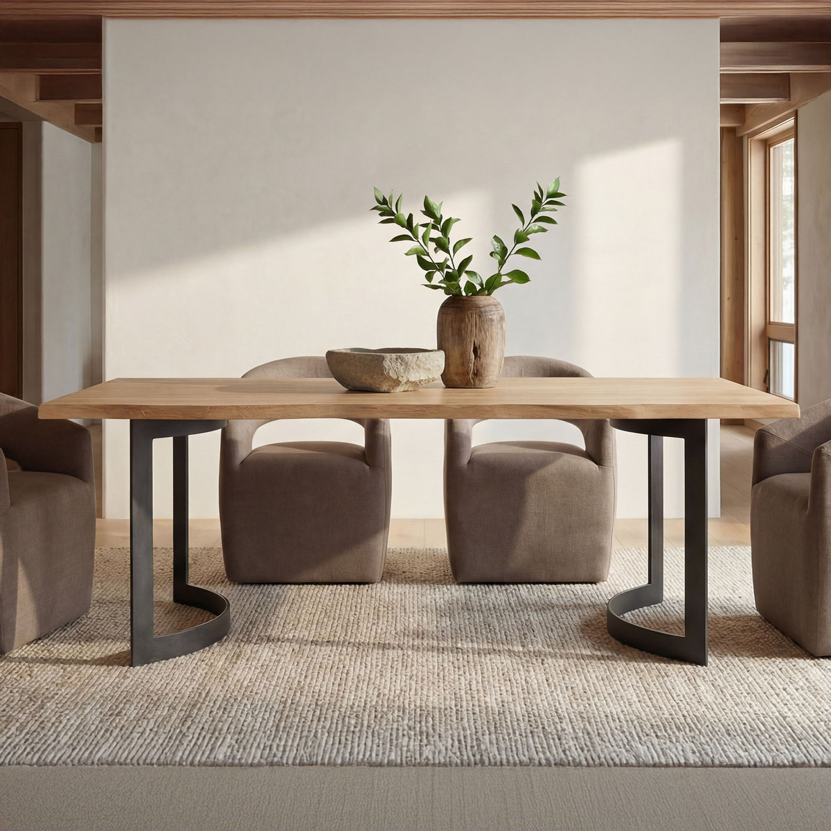 Soft taupe upholstered rolling dining chairs with arched backs around a table