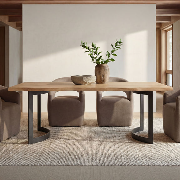 Soft taupe upholstered rolling dining chairs with arched backs around a table