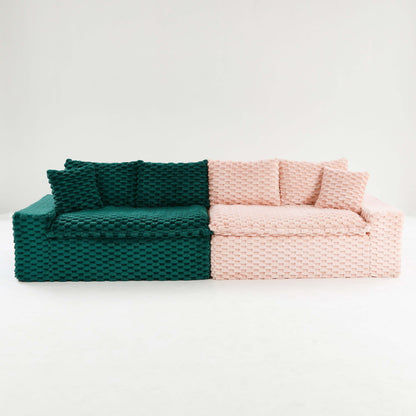 Two-tone woven sofa with dark green left seat and light pink right cushions