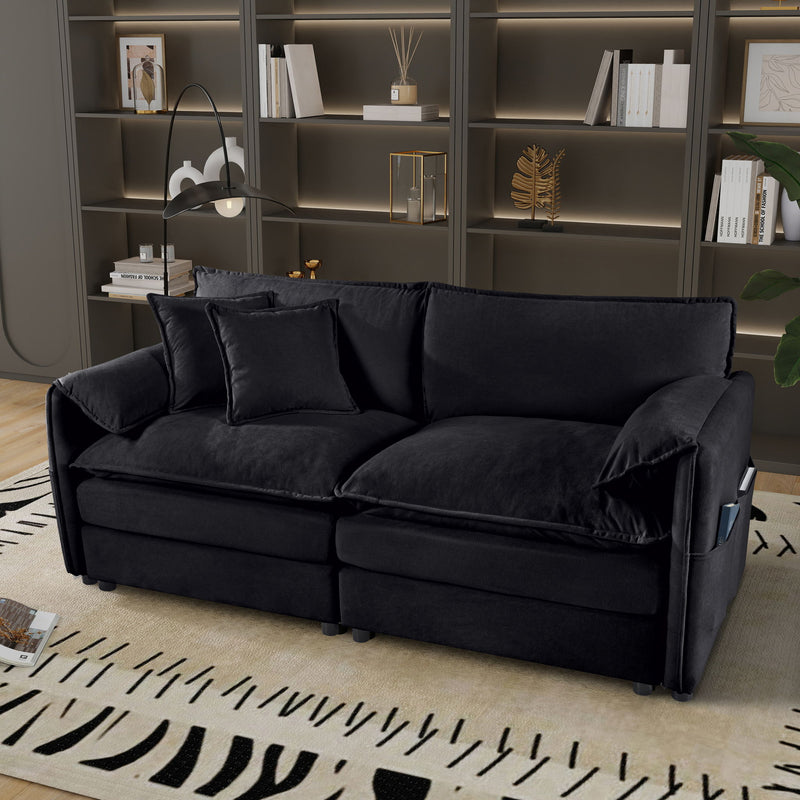 Black loveseat sofa with thick seat cushions and multiple back pillows, track arms