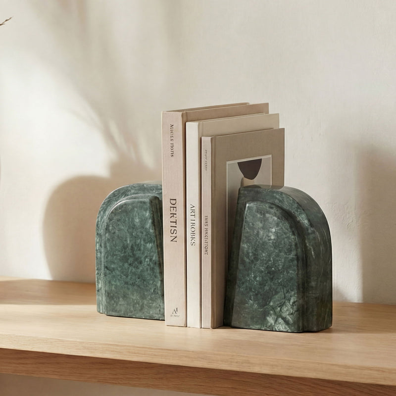 Green marble bookends with rounded ends, stacked on a shelf beside books