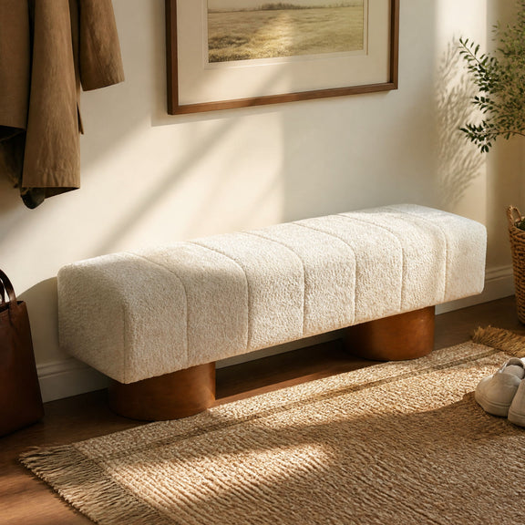 Beige upholstered dining bench with tufted seat and rounded wooden legs