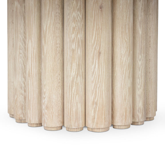 Cream washed dining table base with vertical fluted wood columns.