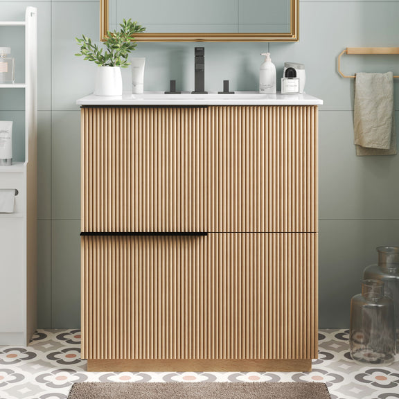 Light brown fluted bathroom vanity with white ceramic sink and center handle bar