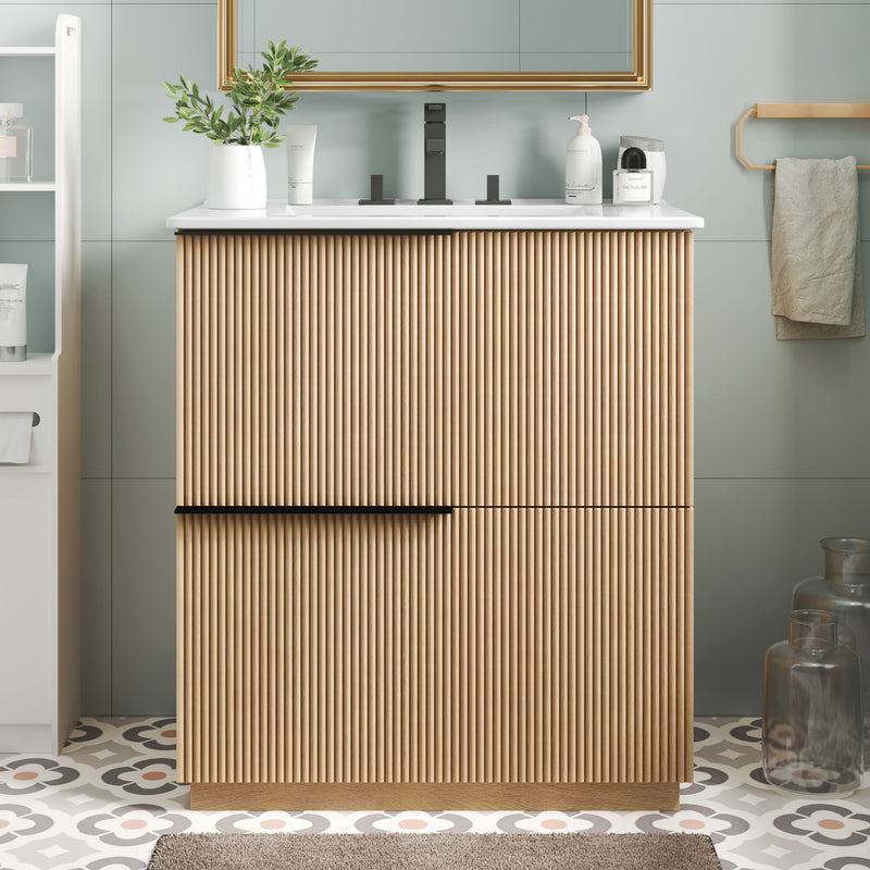 Light brown fluted bathroom vanity with white ceramic sink and center handle bar