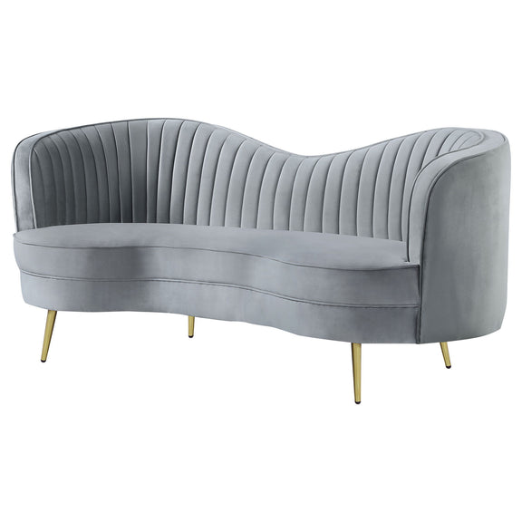 Gray channel-tufted loveseat with curved back, rounded arms, and gold legs