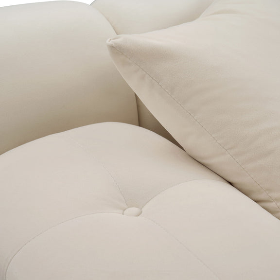 Close-up of light beige sectional sofa corner with seam stitching and armrest cushion