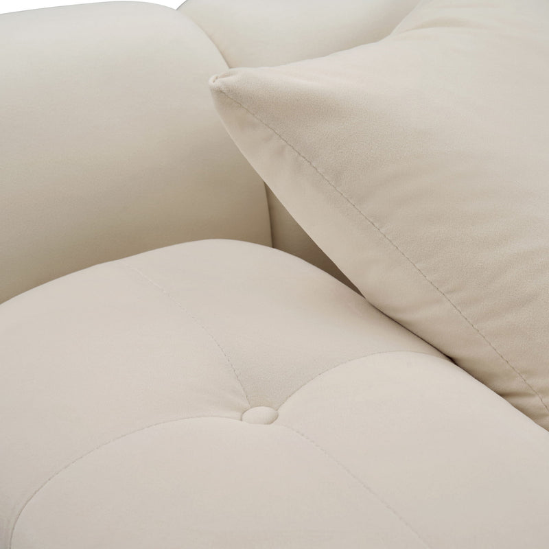 Close-up of light beige sectional sofa corner with seam stitching and armrest cushion