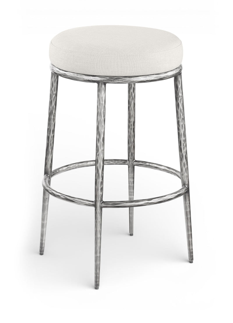White upholstered round backless bar stool with antique silver metal legs and footrest
