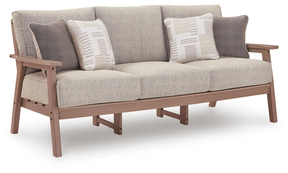 Gray fabric sofa with driftwood frame, wide arms, and two striped throw pillows