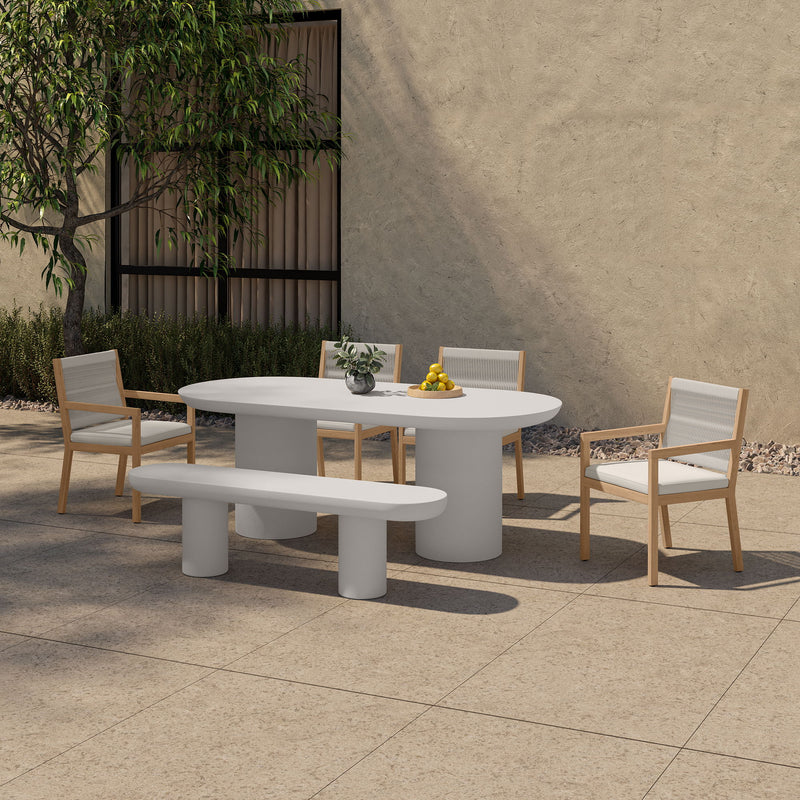 Cream oval dining table with pedestal legs for outdoor dining