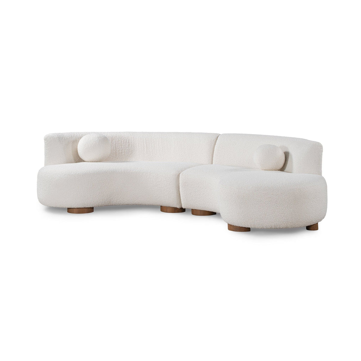 Ivory sectional sofa corner with rounded back and two bolster pillows