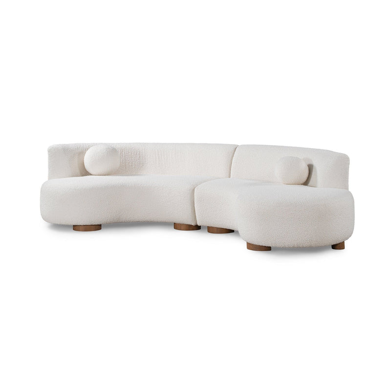 Ivory sectional sofa corner with rounded back and two bolster pillows