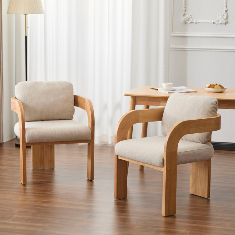 Pair of beige cushioned dining chairs with curved wood frames, shown around a table