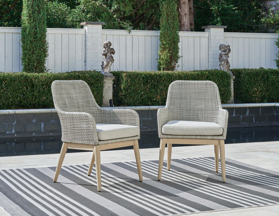 Two gray woven armchairs with seat cushions and light wood legs