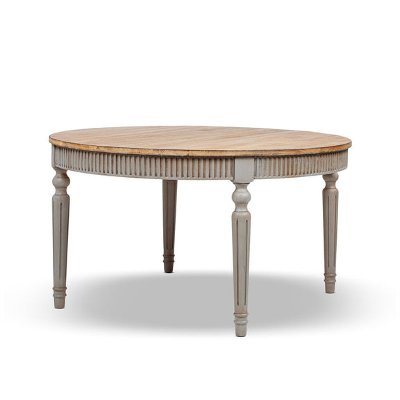 Round dining table with light wood top, ridged apron, and turned gray legs