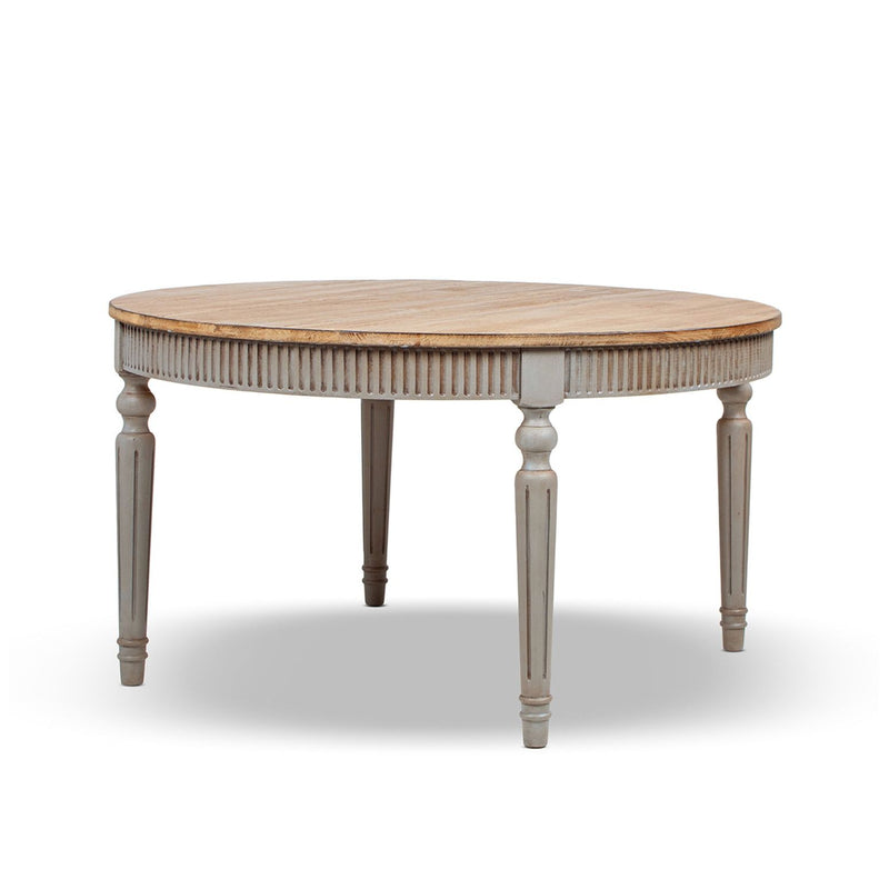 Round dining table with light wood top, ridged apron, and turned gray legs