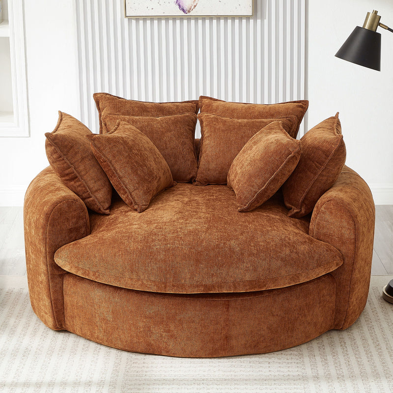 Round orange chaise sofa with matching throw pillows and curved arms