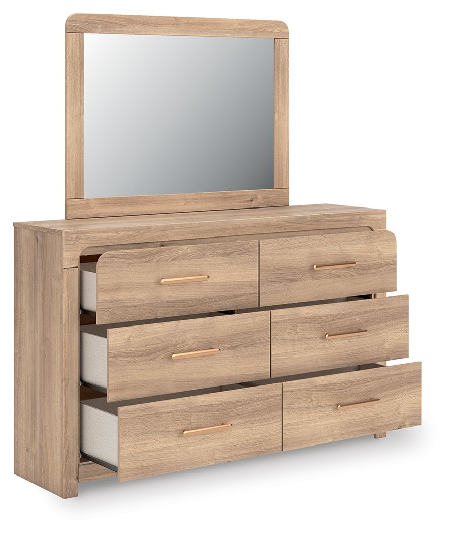 Tan dresser with arched mirror, stacked drawer layout and gold bar pulls