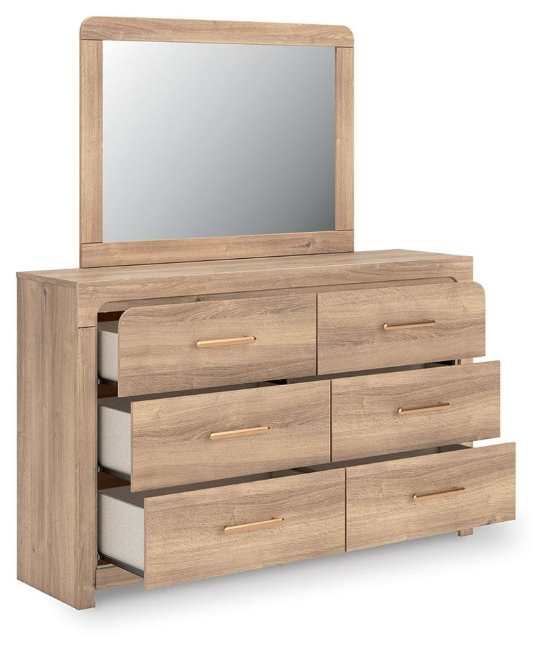 Tan dresser with arched mirror, stacked drawer layout and gold bar pulls