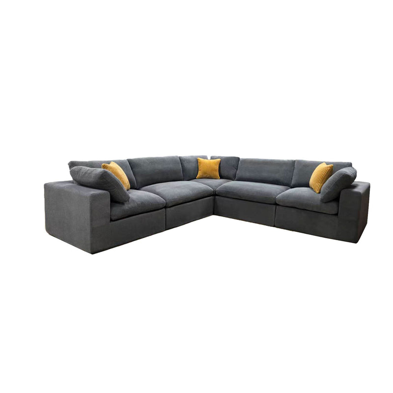 Gray modular sectional sofa with corner chaise and yellow throw pillows