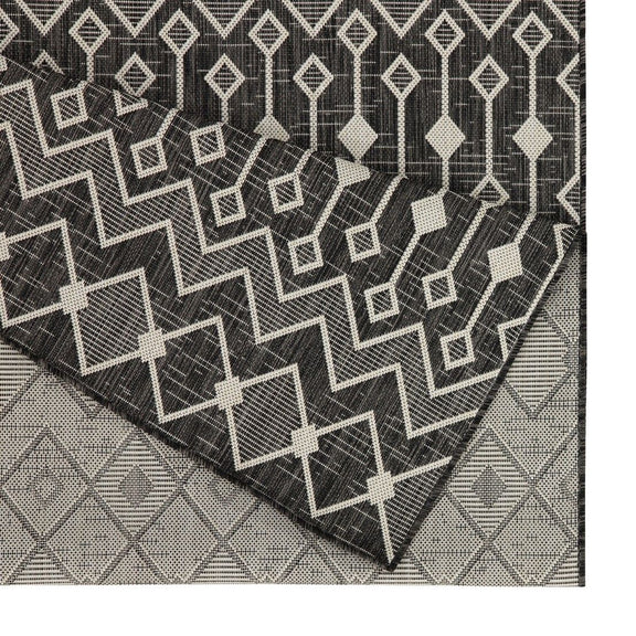 Geometric dark gray polypropylene area rug with white zigzag lattice pattern