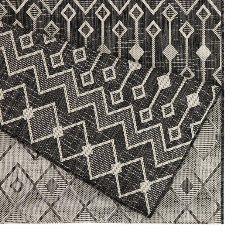Geometric dark gray polypropylene area rug with white zigzag lattice pattern